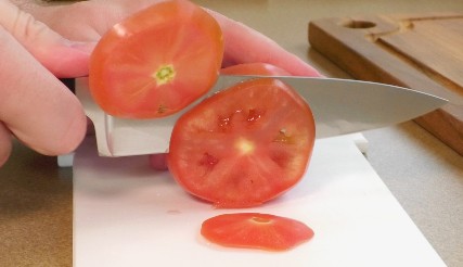 A.G. Russell 6" Chef's Knife cutting a tomato